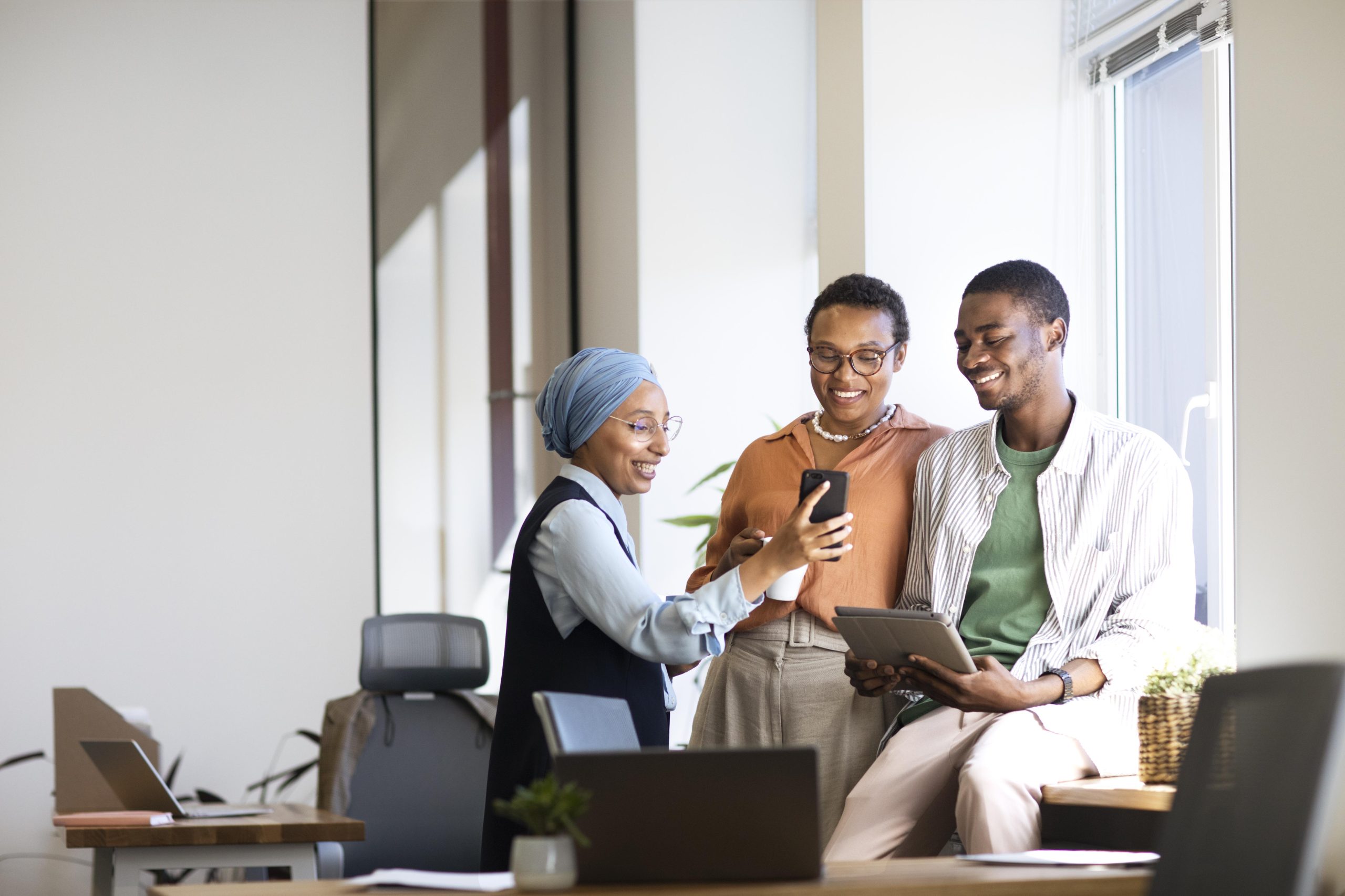 new male employee conversing with female colleagues his new office job